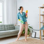 woman having fun while cleaning the house